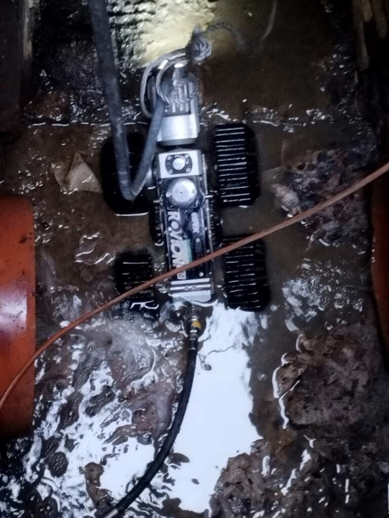 Telecamera robotizzata durante il controllo interno di una tubazione fognaria.